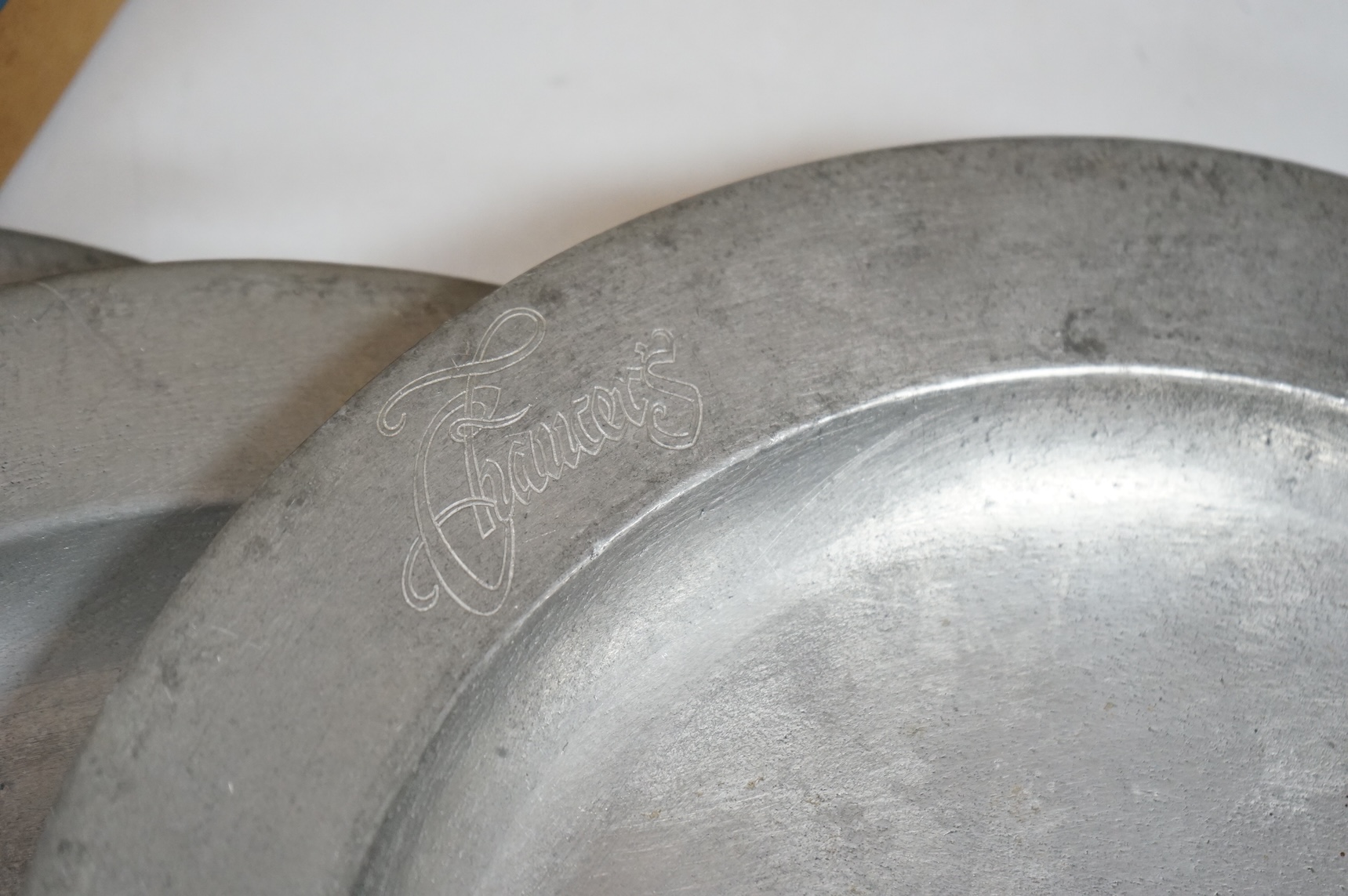Two 19th century pewter chargers and a set of six pewter plates, largest 42cm in diameter